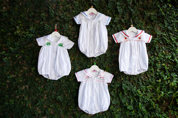 white embroidered baby rompers